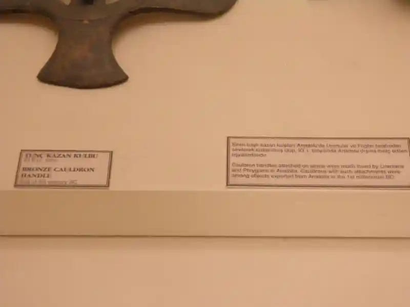 Cauldron handle in a form of a winged man with a solar disc body